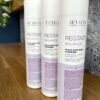 Three 250 ml bottles of Re/Start Balance Scalp Soothing Cleanser are displayed on a wooden surface, set against a textured wall background.