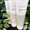 Three 200 ml tubes of Re/Start Curls Nourishing Conditioner and Leave-In stand upright with green plants in the background, emphasizing their nourishing benefits for curls.