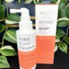 A Re/Start Density Anti Hair Loss Direct Spray bottle is shown beside its packaging, with green leaves in the background.