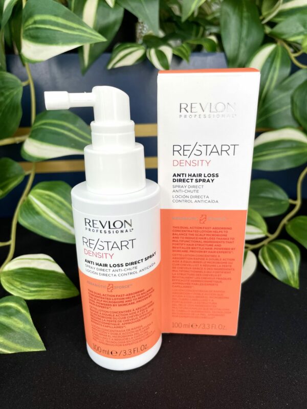 A Re/Start Density Anti Hair Loss Direct Spray bottle is shown beside its packaging, with green leaves in the background. A Re/Start Density Anti Hair Loss Direct Spray bottle is shown beside its packaging, with green leaves in the background.