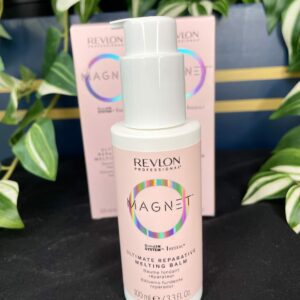 A bottle of Revlon Magnet Ultimate Repairative Melting Balm 100ml is displayed in front of its packaging, with green plants in the background.