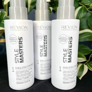 Three bottles of Style Master Endless Control Restyling Fluid 150ml are shown in front of vibrant green leafy plants.