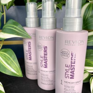 Three bottles of Style Masters Memory Spray 150ml are displayed in front of vibrant green-striped plants.