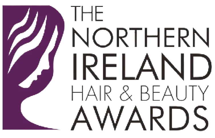 Logo for The Northern Ireland Hair & Beauty Awards, featuring a stylized profile of a face with purple hair beside the event name in bold, modern lettering, proudly representing MACC Credentials.